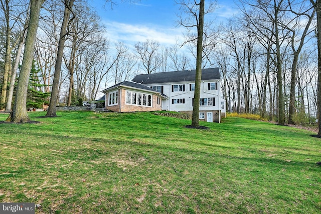 back of house with a lawn