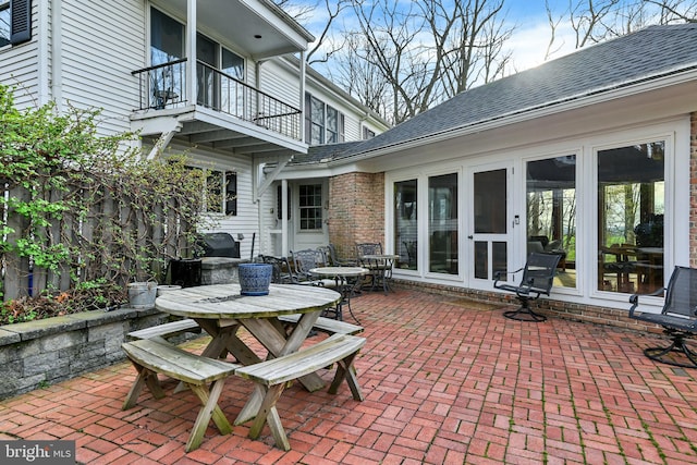 view of patio featuring a balcony