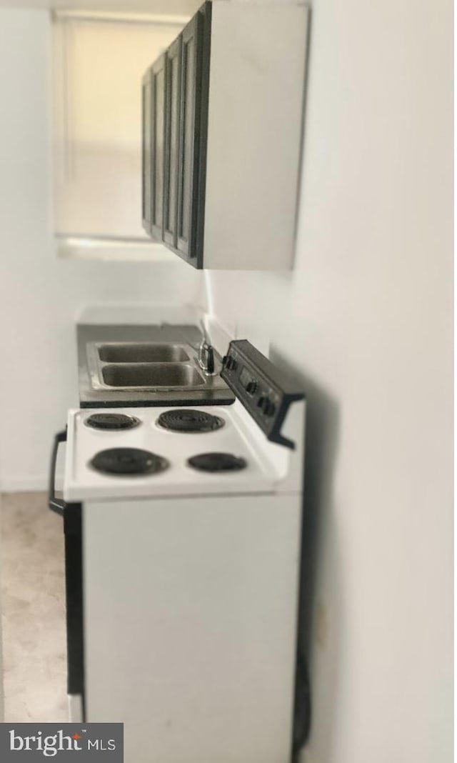 room details featuring light tile floors, sink, and white electric range oven