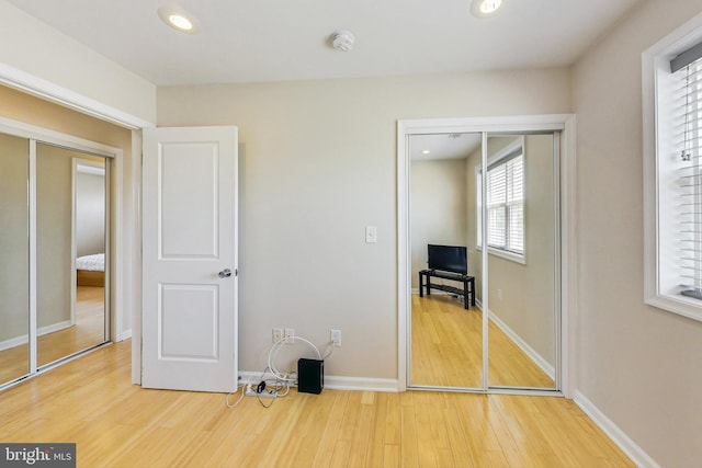 unfurnished bedroom featuring light wood-type flooring