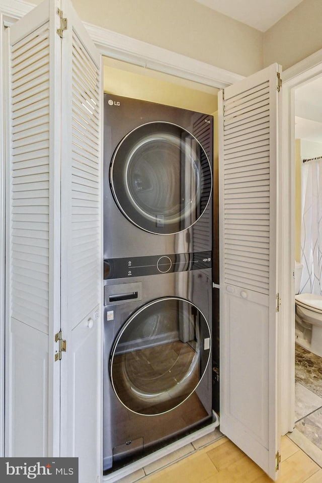 washroom with stacked washer / drying machine