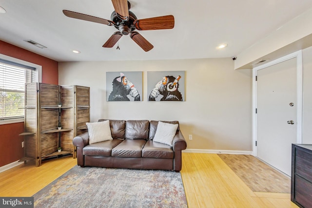 living room with hardwood / wood-style flooring and ceiling fan