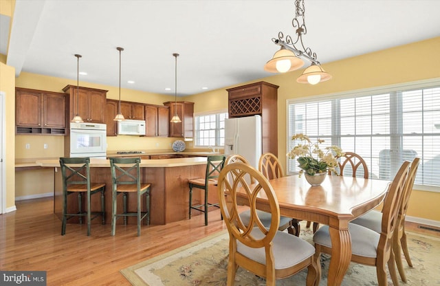 dining area with light hardwood / wood-style flooring