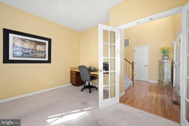 office with french doors and light wood-type flooring