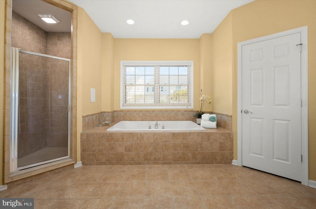 bathroom featuring tile flooring and shower with separate bathtub