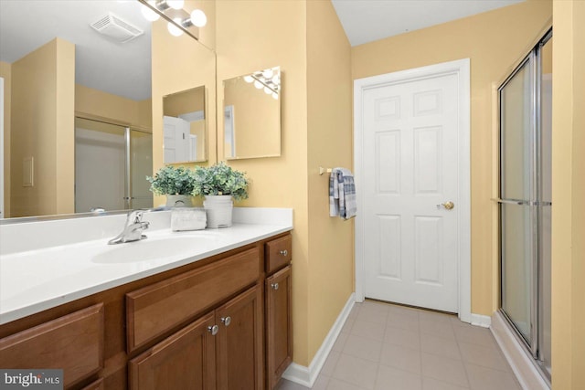 bathroom with a shower with door, tile flooring, and large vanity