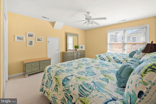 bedroom with light carpet, multiple windows, and ceiling fan