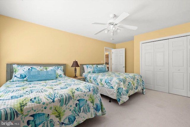 carpeted bedroom featuring a closet and ceiling fan