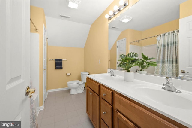 full bathroom featuring large vanity, double sink, lofted ceiling, tile floors, and toilet