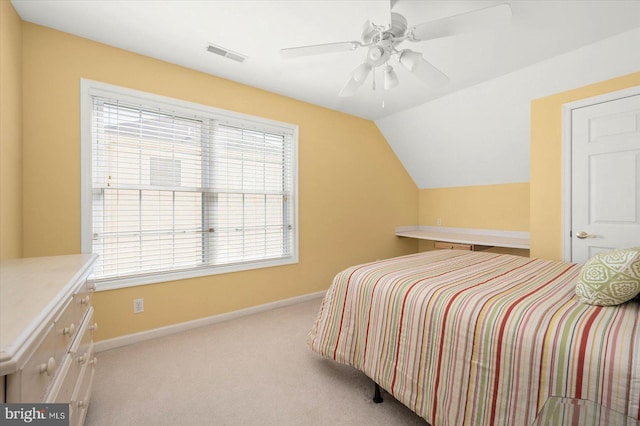 bedroom featuring ceiling fan, vaulted ceiling, and light carpet