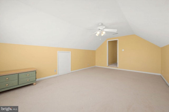 bonus room with ceiling fan, vaulted ceiling, and light carpet