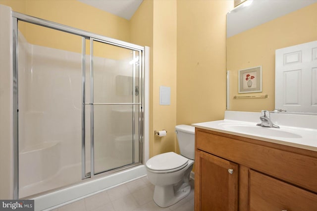 bathroom with a shower with door, tile flooring, toilet, and large vanity