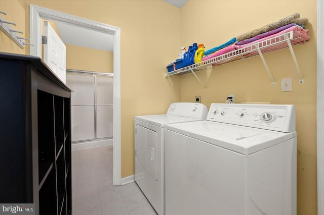 clothes washing area featuring hookup for an electric dryer, independent washer and dryer, and light tile floors