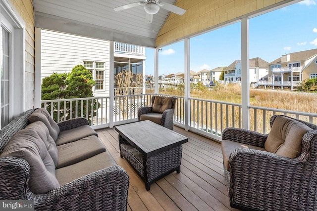 sunroom featuring vaulted ceiling and ceiling fan