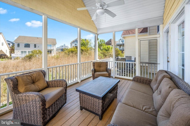 sunroom featuring lofted ceiling and ceiling fan