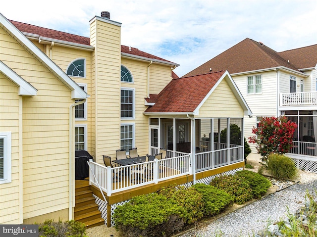 rear view of house with a sunroom