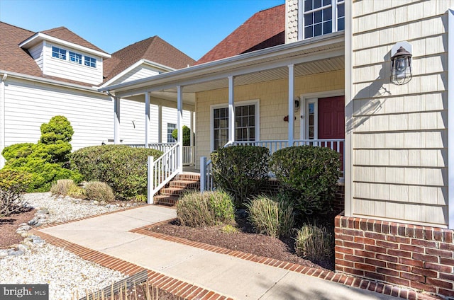 view of exterior entry featuring a porch