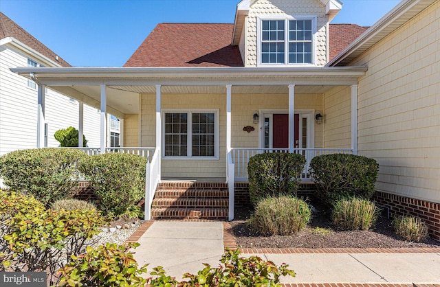 view of exterior entry with covered porch