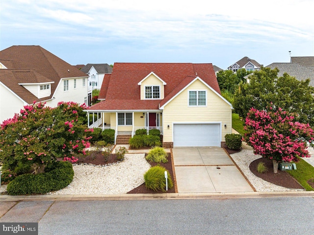 view of front of property featuring covered porch and a garage