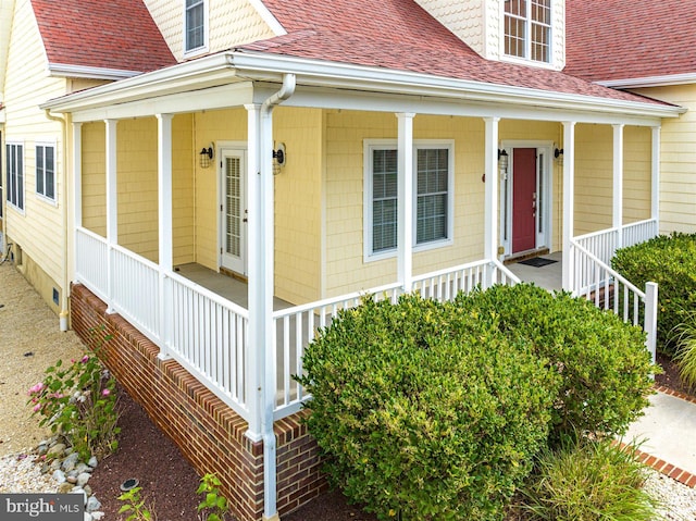 view of exterior entry with covered porch