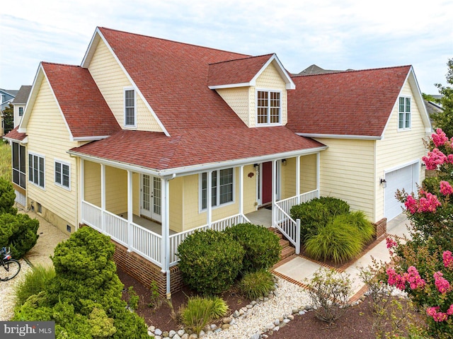 view of front facade with a garage and a porch