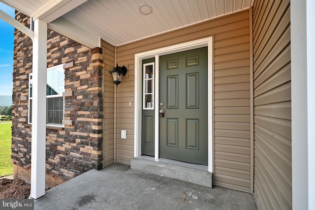 view of exterior entry with covered porch