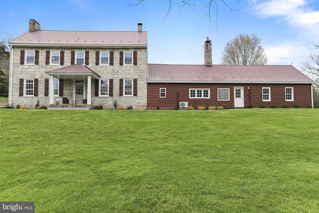 colonial home with a front lawn