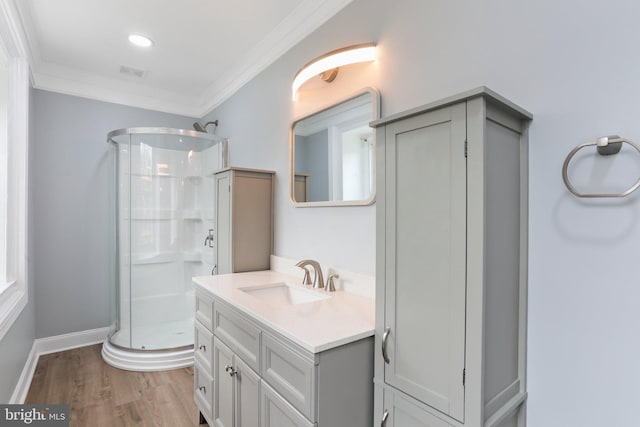 bathroom with walk in shower, oversized vanity, wood-type flooring, and ornamental molding