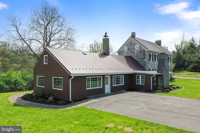 view of front of house with a patio and a front yard