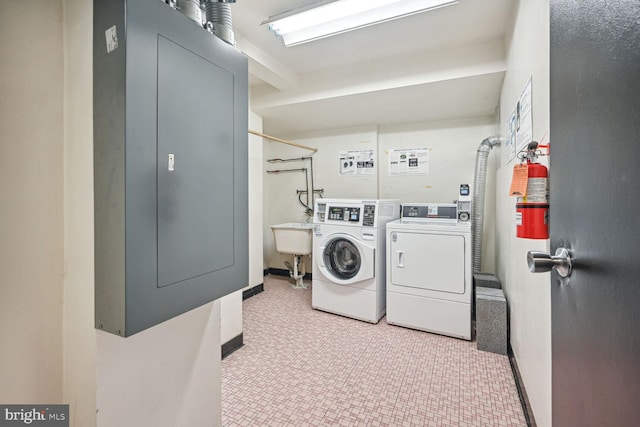 washroom with separate washer and dryer and light tile floors