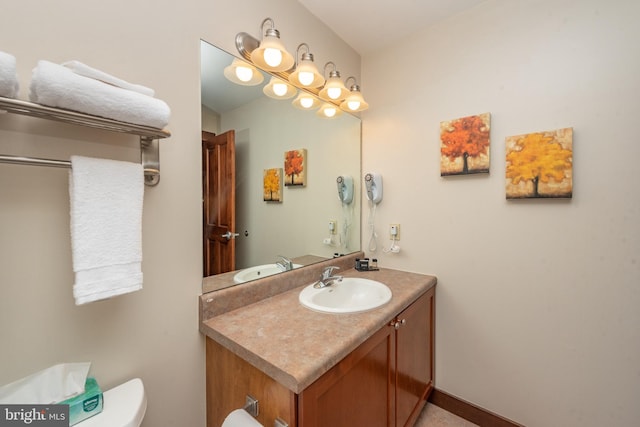 bathroom featuring toilet and large vanity