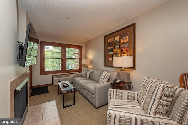 tiled living room featuring a textured ceiling and a fireplace