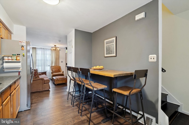 dining space with dark hardwood / wood-style flooring