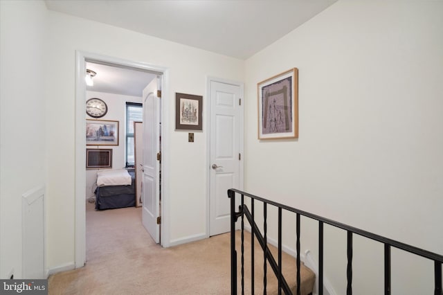 hallway with light colored carpet