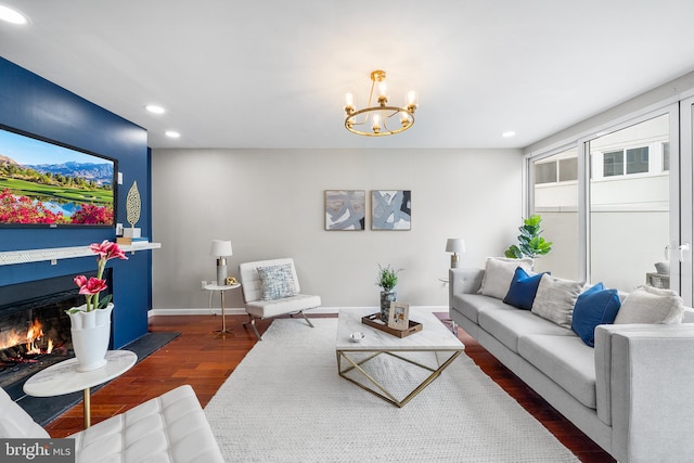 living room with dark hardwood / wood-style floors and a notable chandelier