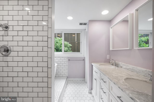 bathroom with walk in shower, dual bowl vanity, and tile floors