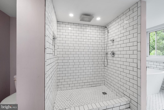 bathroom featuring separate shower and tub