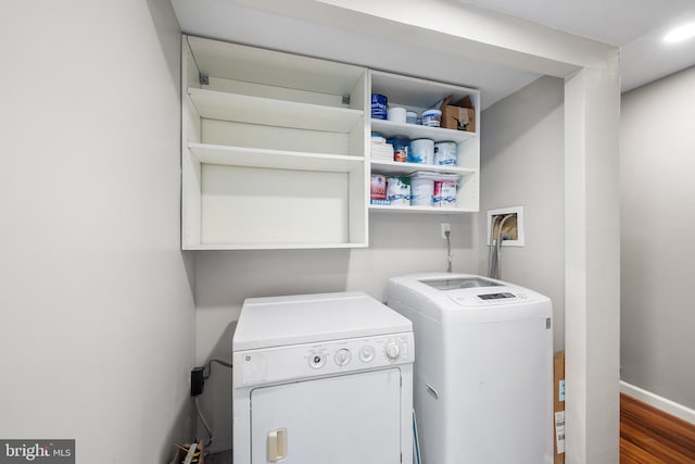 laundry area featuring independent washer and dryer, hardwood / wood-style flooring, and hookup for a washing machine