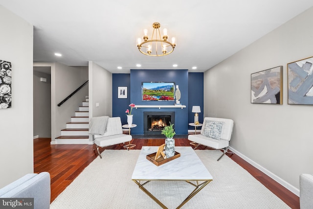 living room featuring an inviting chandelier and dark wood-type flooring