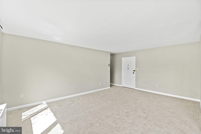 unfurnished room featuring light colored carpet