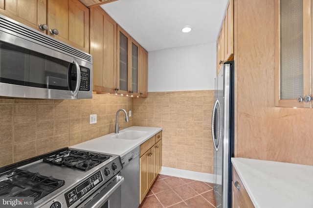 kitchen with sink, stainless steel appliances, tasteful backsplash, and light tile floors