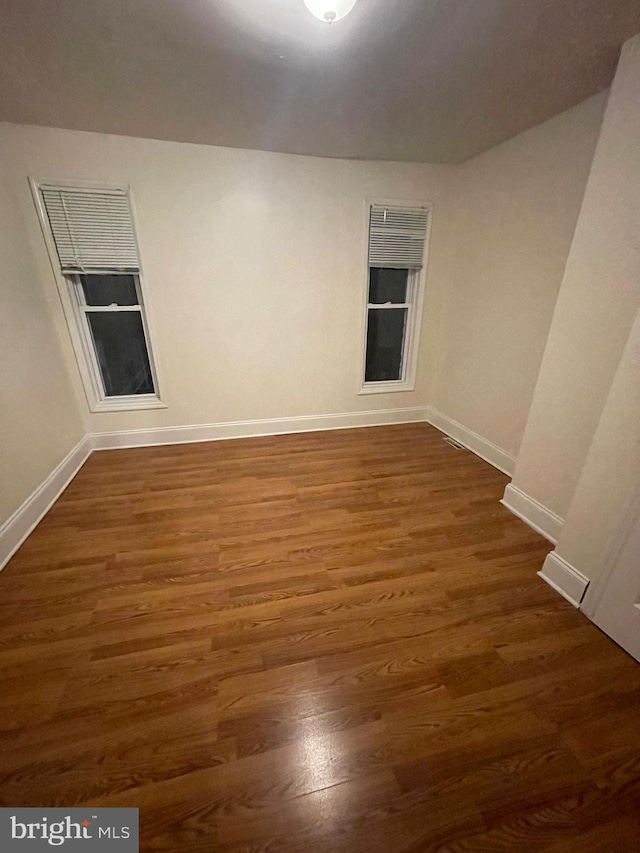 spare room with dark hardwood / wood-style floors