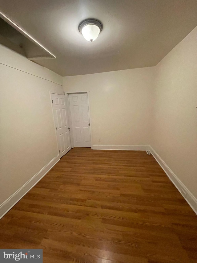 empty room with dark wood-type flooring