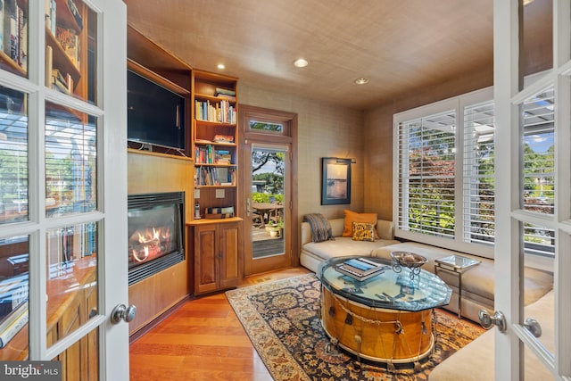 sitting room featuring french doors and light hardwood / wood-style flooring