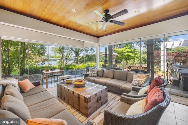 sunroom with ceiling fan and wooden ceiling