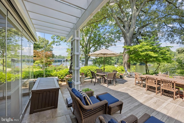 view of patio / terrace with outdoor lounge area and a deck with water view