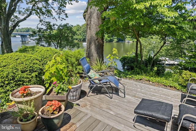 wooden deck featuring a water view