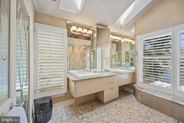 bathroom featuring a skylight, vanity, and walk in shower