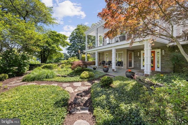 view of yard featuring a pergola and a porch