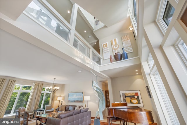 living room with a chandelier and a high ceiling